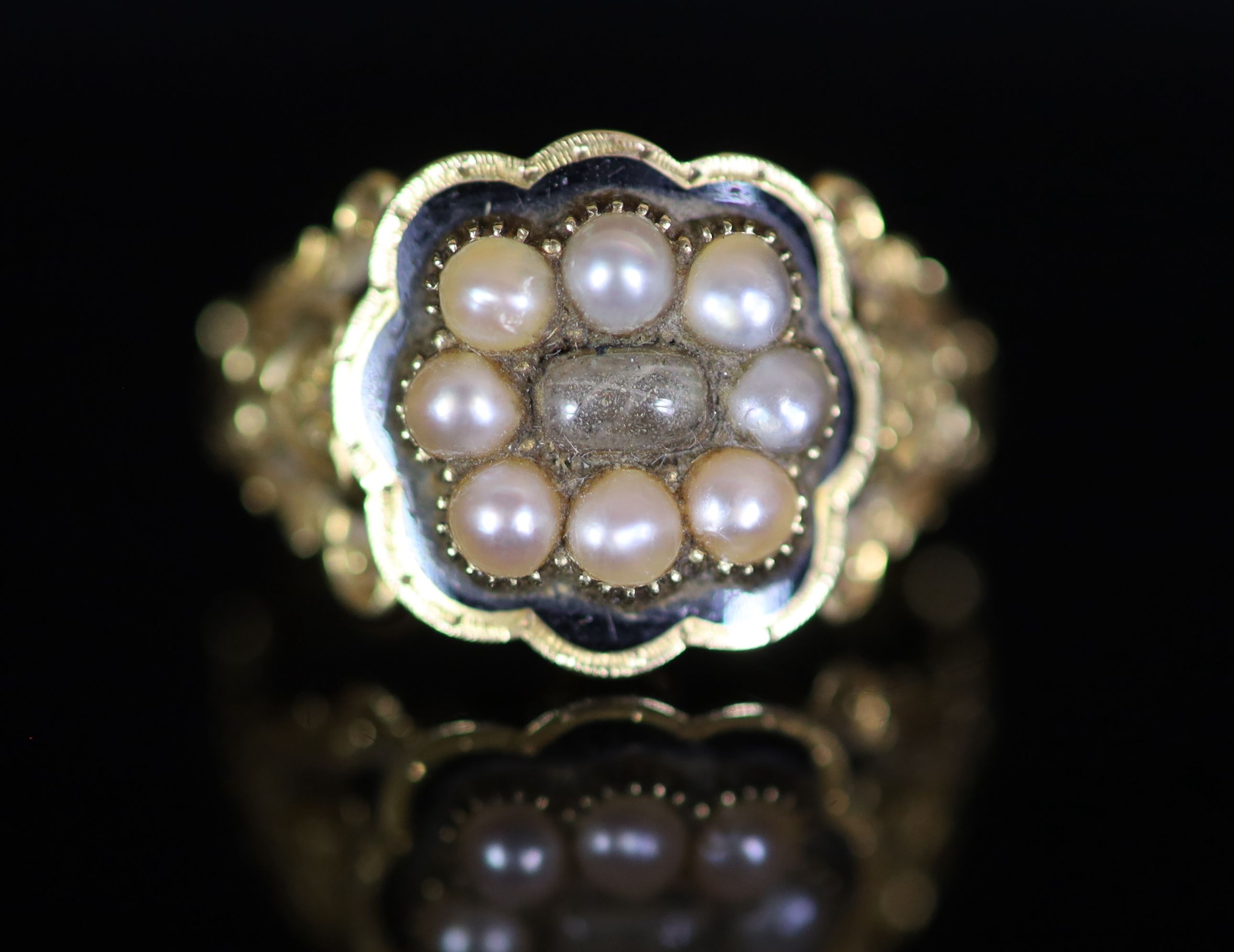 A William IV 18ct gold, black enamel and seed pearl set mourning ring